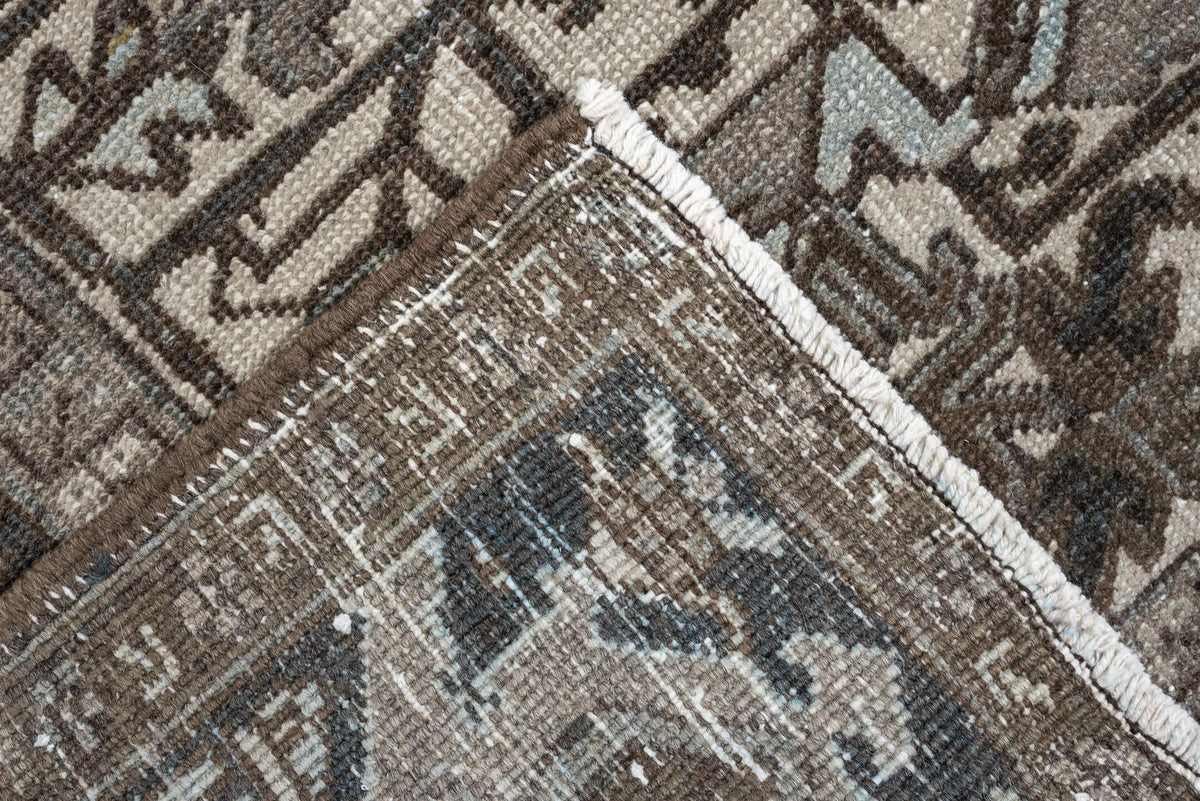 7' x 9' one-of-a-kind handmade antique Heriz large size rug. Color palette: ivory, charcoal, taupe, slate blue, olive, camel
