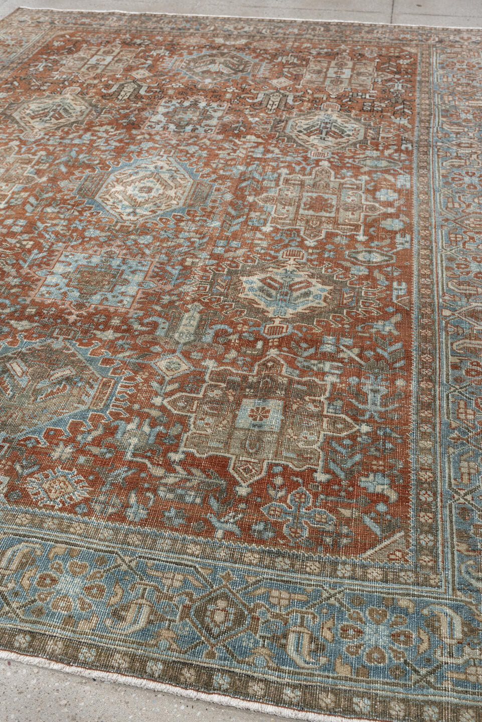 7' x 9' one-of-a-kind handmade antique Heriz large size rug. Color palette: rust, blue gray, ivory, terra cotta, charcoal
