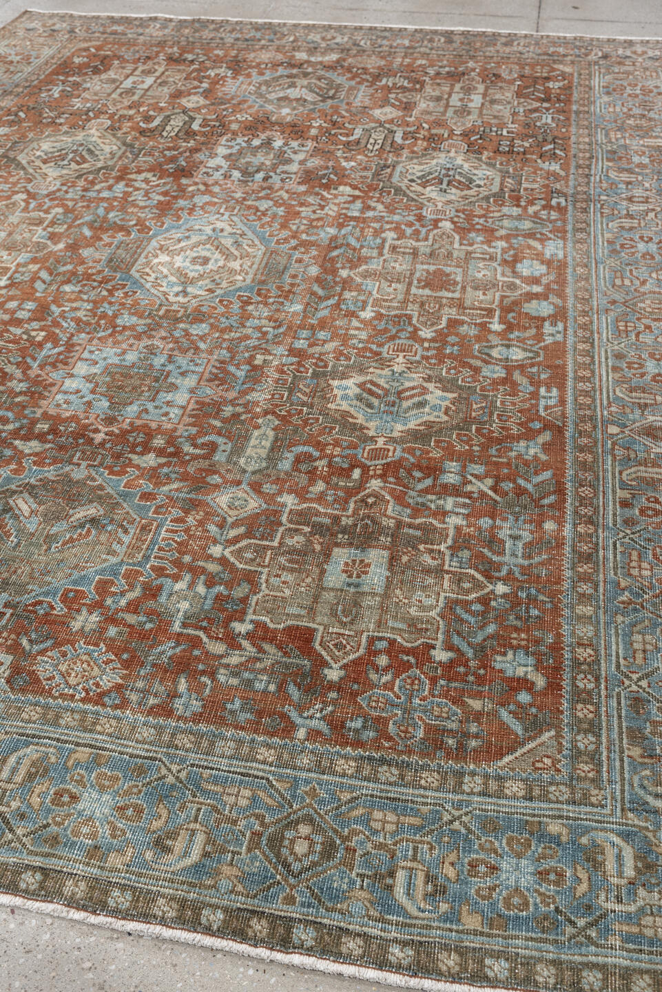 7' x 9' one-of-a-kind handmade antique Heriz large size rug. Color palette: rust, blue gray, ivory, terra cotta, charcoal