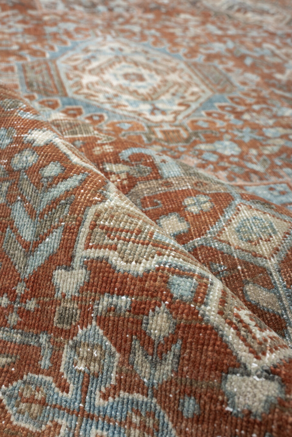 7' x 9' one-of-a-kind handmade antique Heriz large size rug. Color palette: rust, blue gray, ivory, terra cotta, charcoal