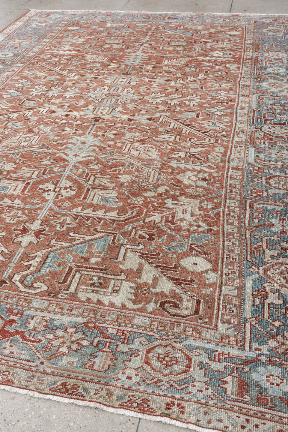 7' x 10' one-of-a-kind handmade antique Heriz large size rug. Color palette: terra cotta, ivory, blue gray, rust, pale blue