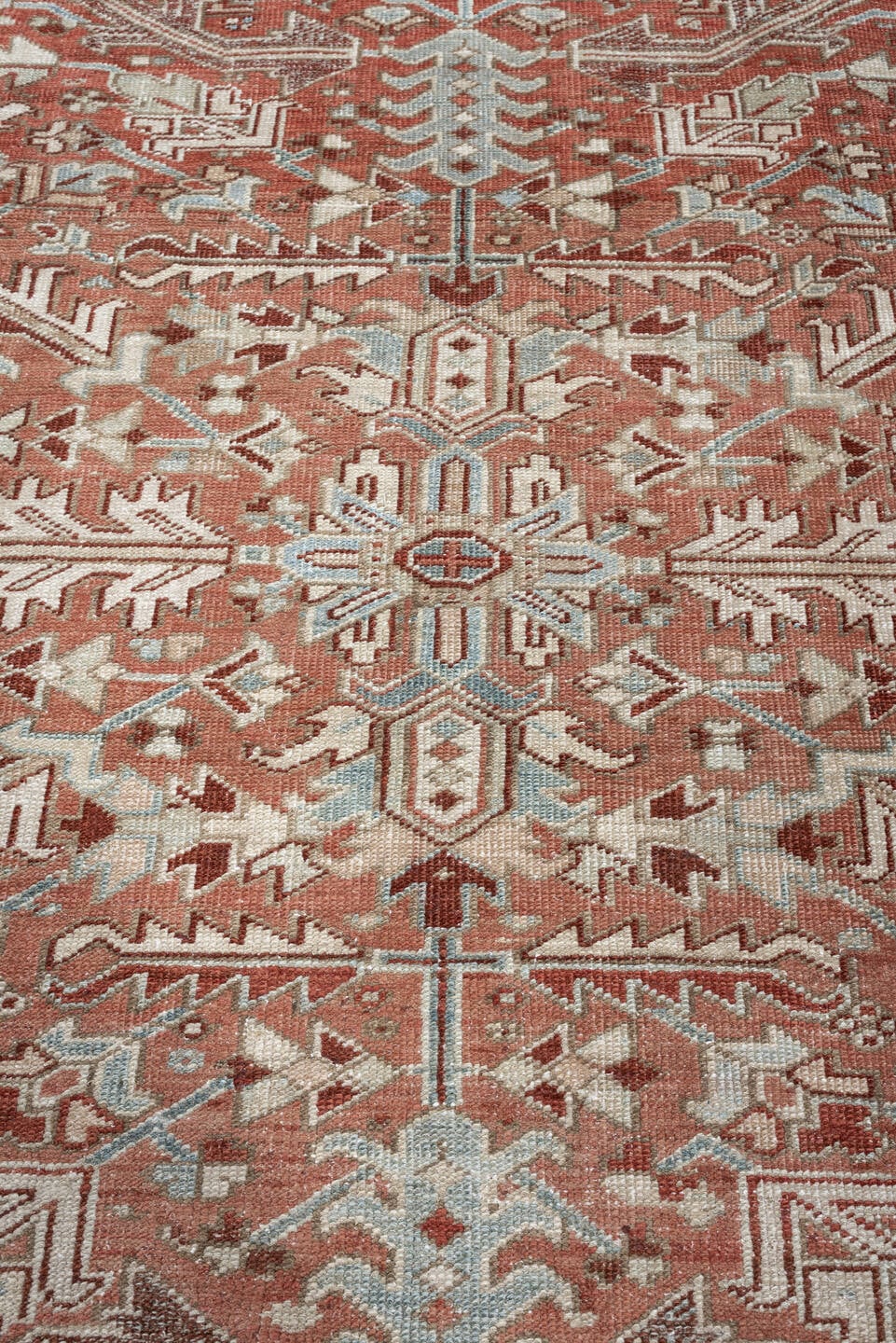 7' x 10' one-of-a-kind handmade antique Heriz large size rug. Color palette: terra cotta, ivory, blue gray, rust, pale blue