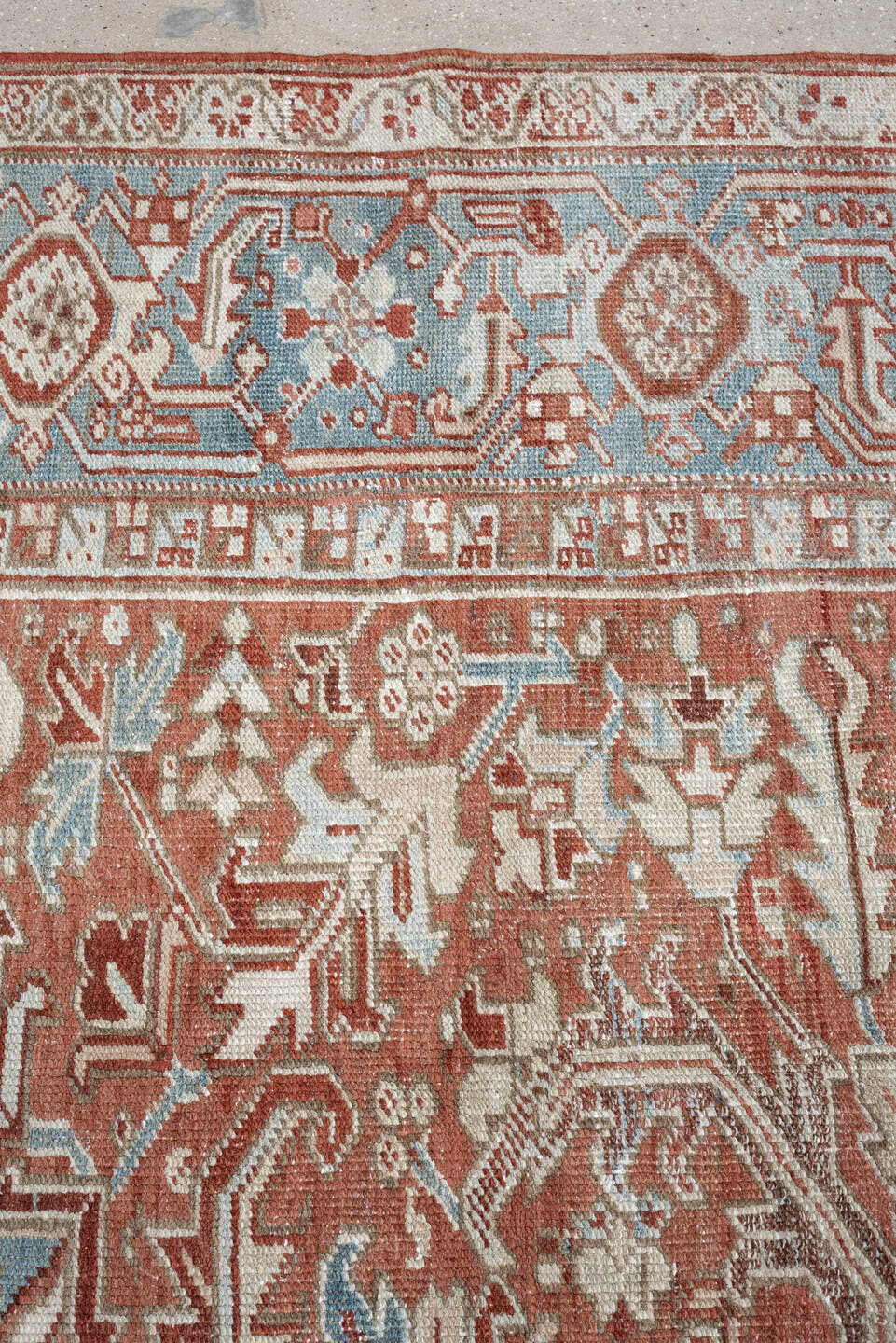 7' x 10' one-of-a-kind handmade antique Heriz large size rug. Color palette: terra cotta, ivory, blue gray, rust, pale blue