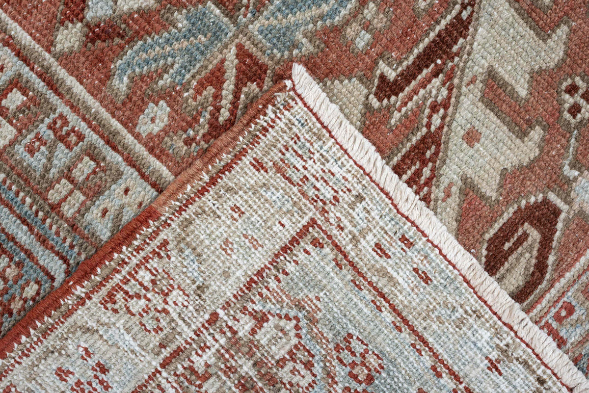 7' x 10' one-of-a-kind handmade antique Heriz large size rug. Color palette: terra cotta, ivory, blue gray, rust, pale blue
