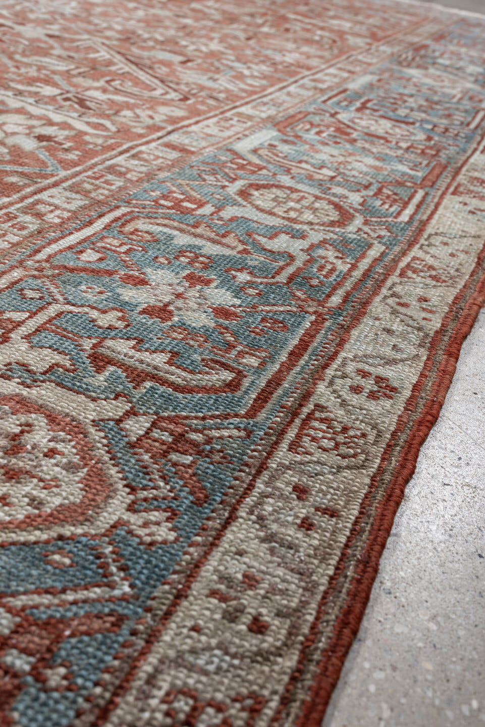 7' x 10' one-of-a-kind handmade antique Heriz large size rug. Color palette: terra cotta, ivory, blue gray, rust, pale blue