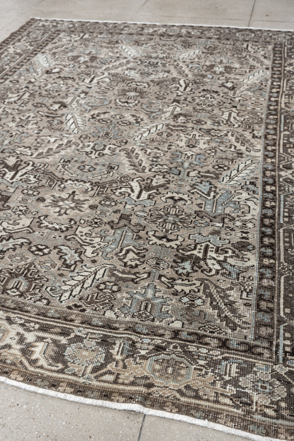 7' x 9' one-of-a-kind handmade antique Heriz large size rug. Color palette: ivory, taupe, charcoal, pale blue, gray, brown