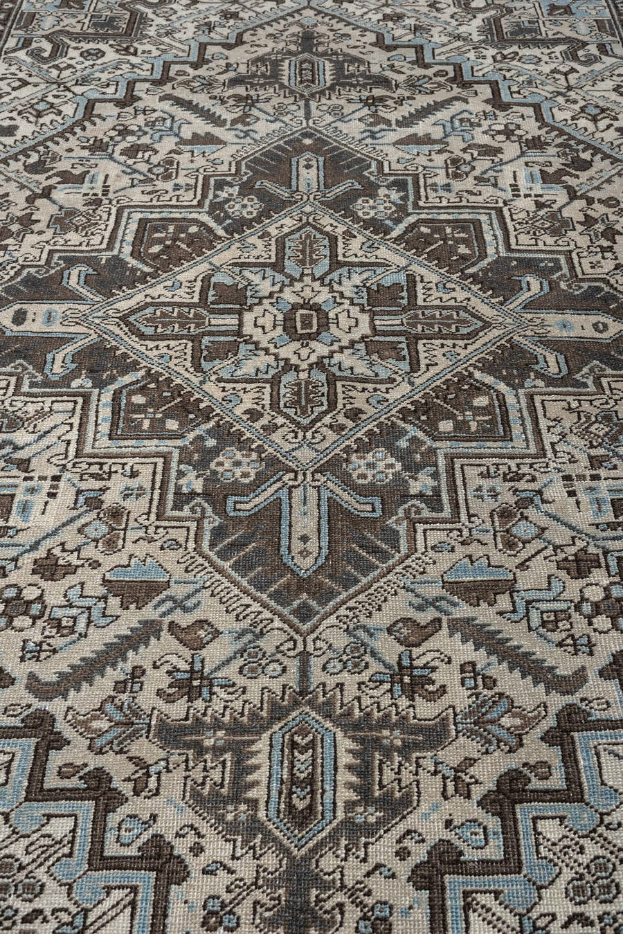 6' x 9' one-of-a-kind handmade antique Heriz medium size rug. Color palette: ivory, charcoal brown, pale blue, taupe, brown