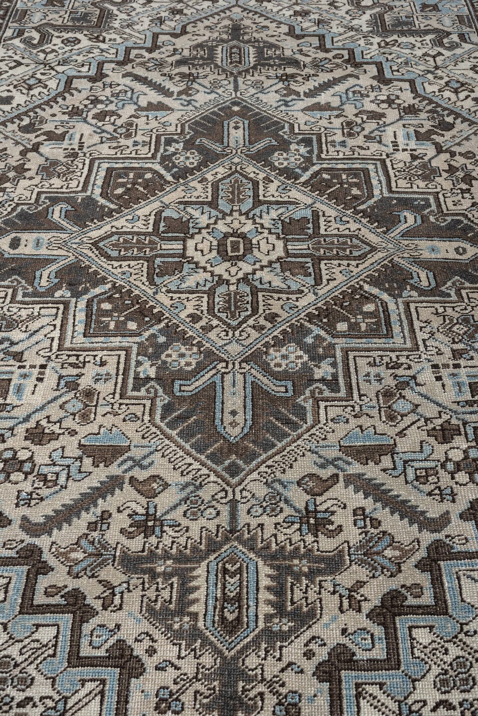 6' x 9' one-of-a-kind handmade antique Heriz medium size rug. Color palette: ivory, charcoal brown, pale blue, taupe, brown