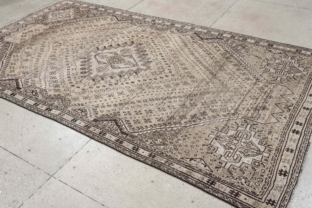 5' x 9' one-of-a-kind handmade antique Shiraz medium size rug. Color palette: ivory, taupe, charcoal, brown, camel, ebony