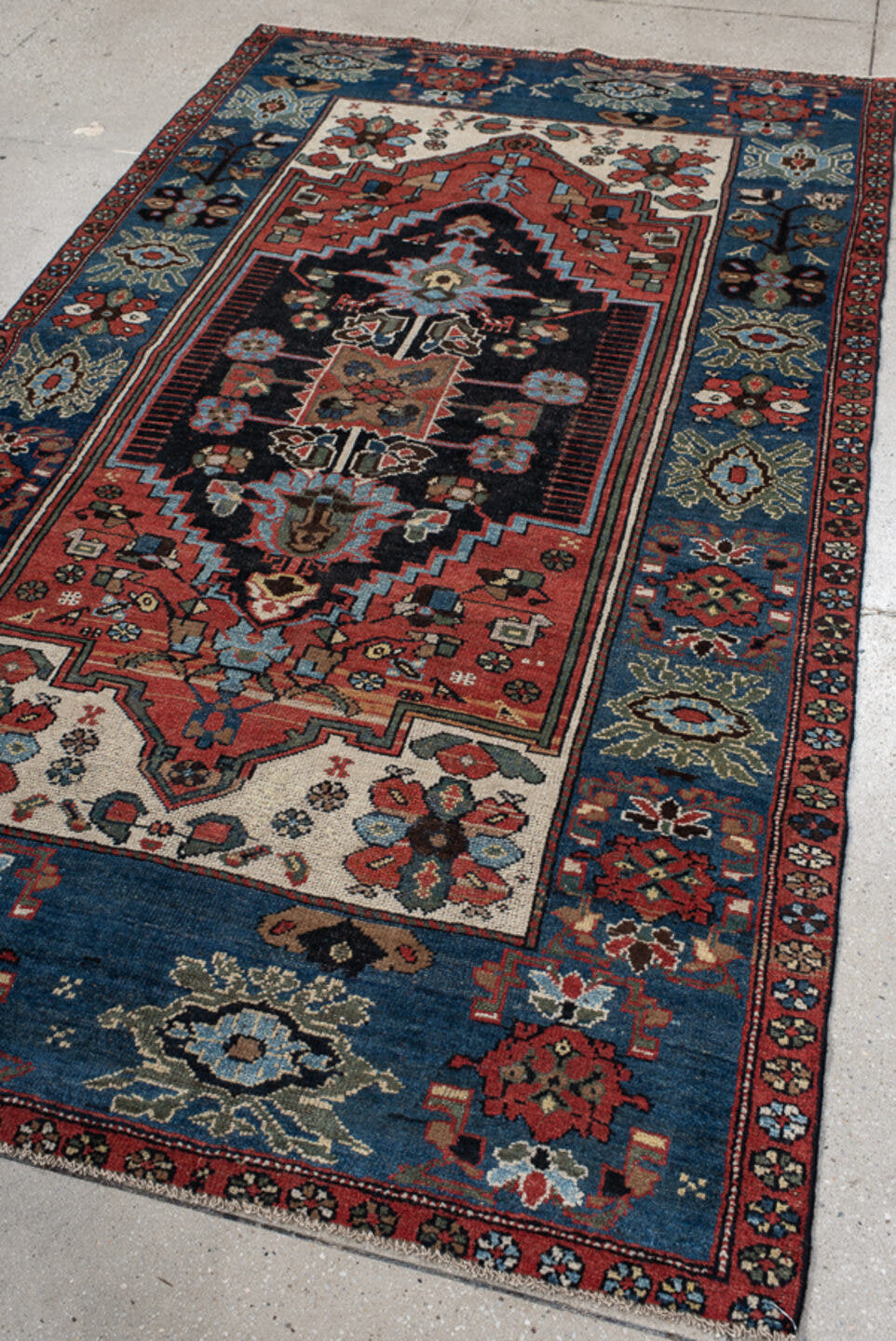 4' x 8' one-of-a-kind handmade vintage rug. Color palette: navy, rust, ivory, sky blue, black, crimson, sage, camel, blue