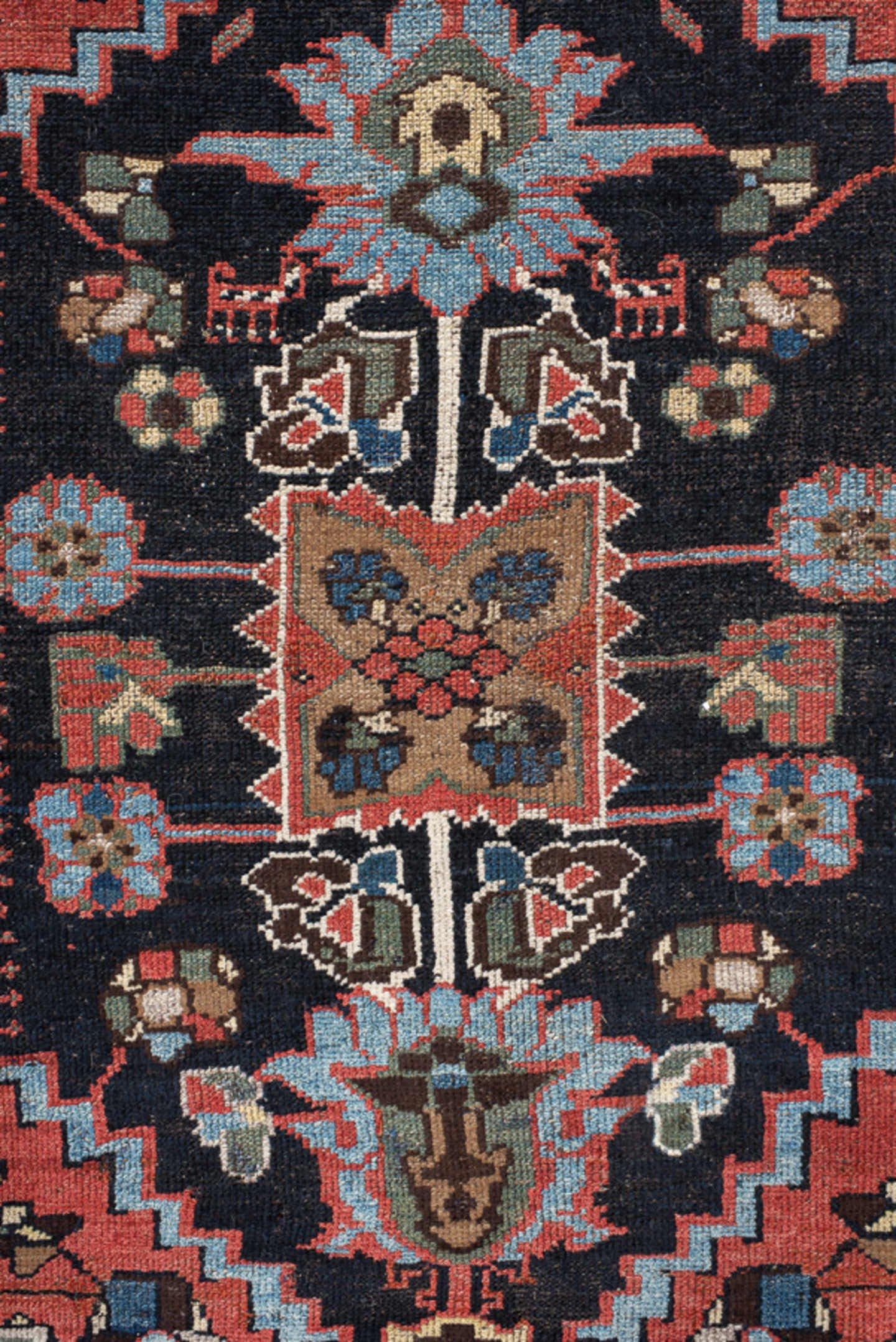 4' x 8' one-of-a-kind handmade vintage rug. Color palette: navy, rust, ivory, sky blue, black, crimson, sage, camel, blue