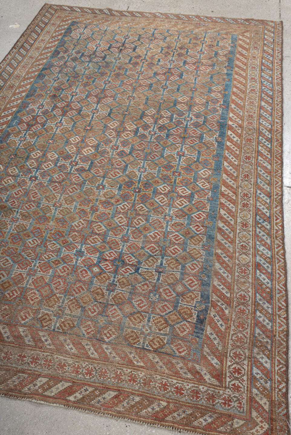 4' x 7' one-of-a-kind handmade vintage Shiraz rug. Color palette: terra cotta, camel, blue, ivory, rust, taupe, terracotta
