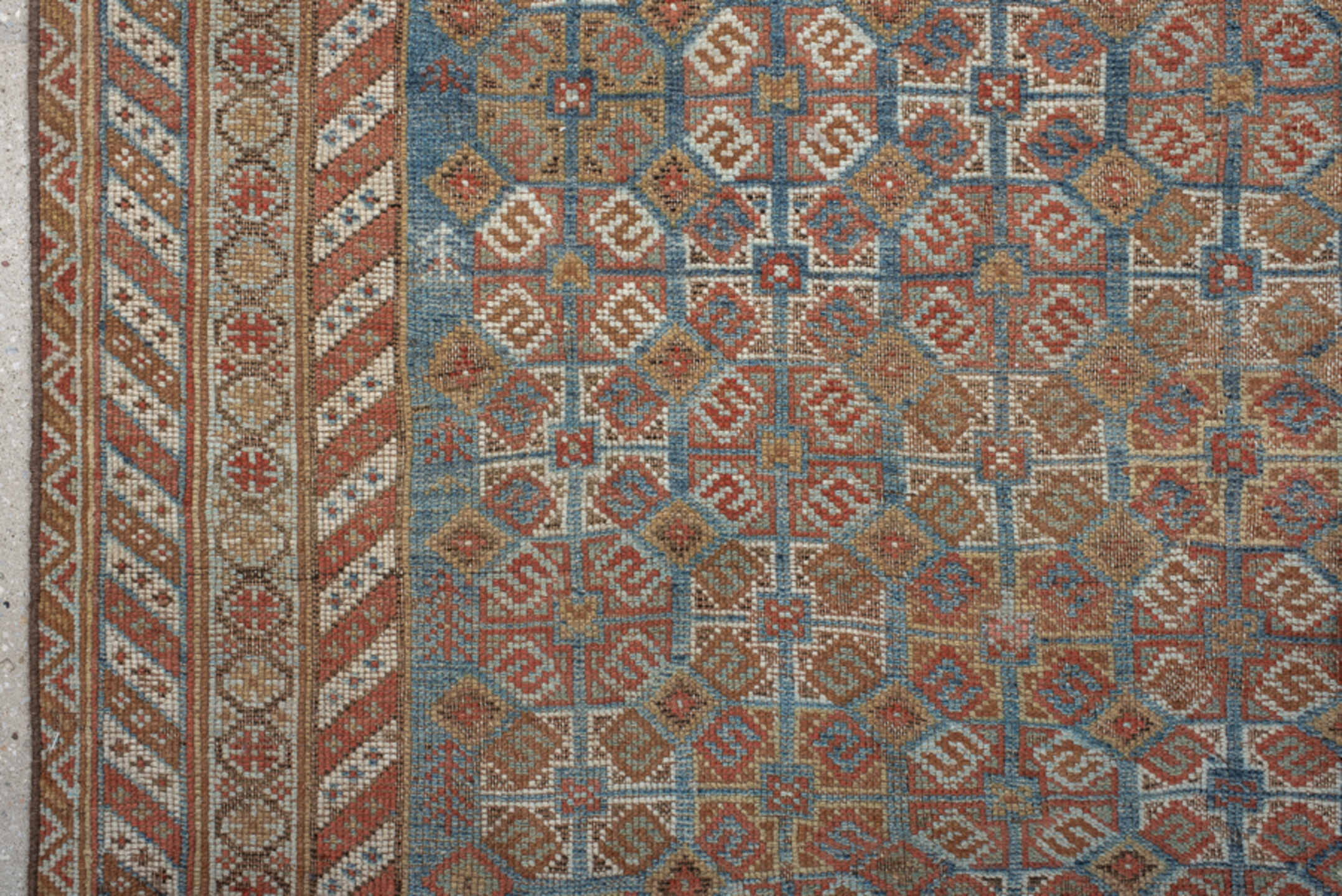 4' x 7' one-of-a-kind handmade vintage Shiraz rug. Color palette: terra cotta, camel, blue, ivory, rust, taupe, terracotta