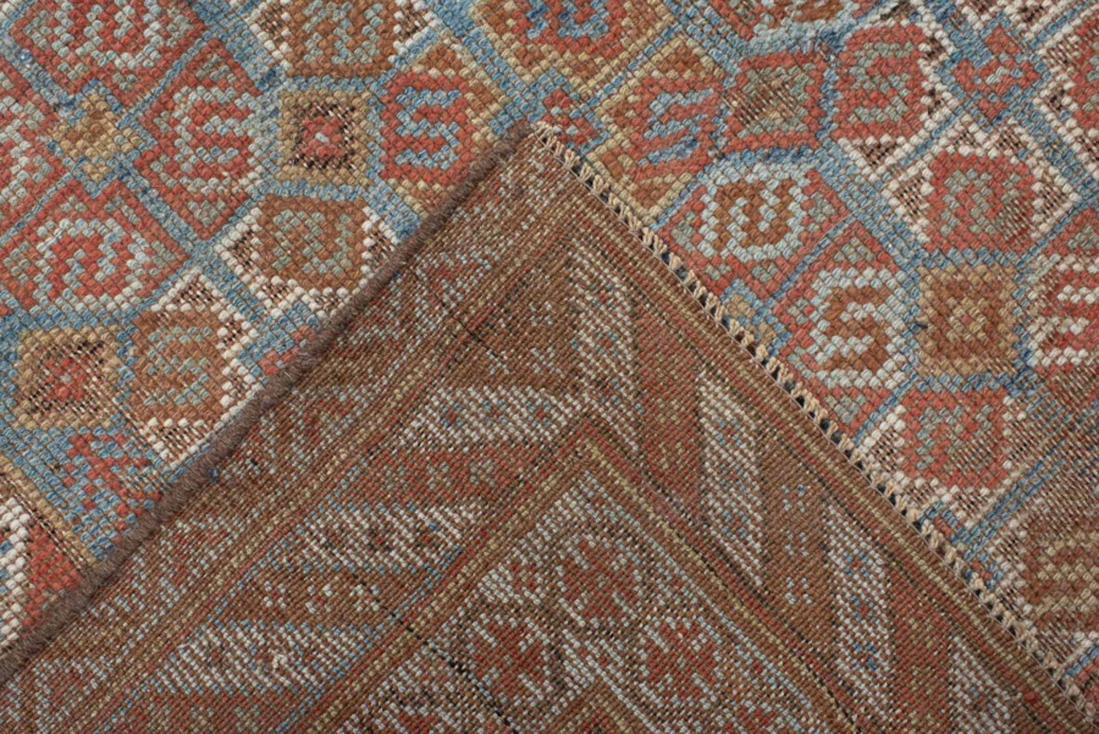 4' x 7' one-of-a-kind handmade vintage Shiraz rug. Color palette: terra cotta, camel, blue, ivory, rust, taupe, terracotta