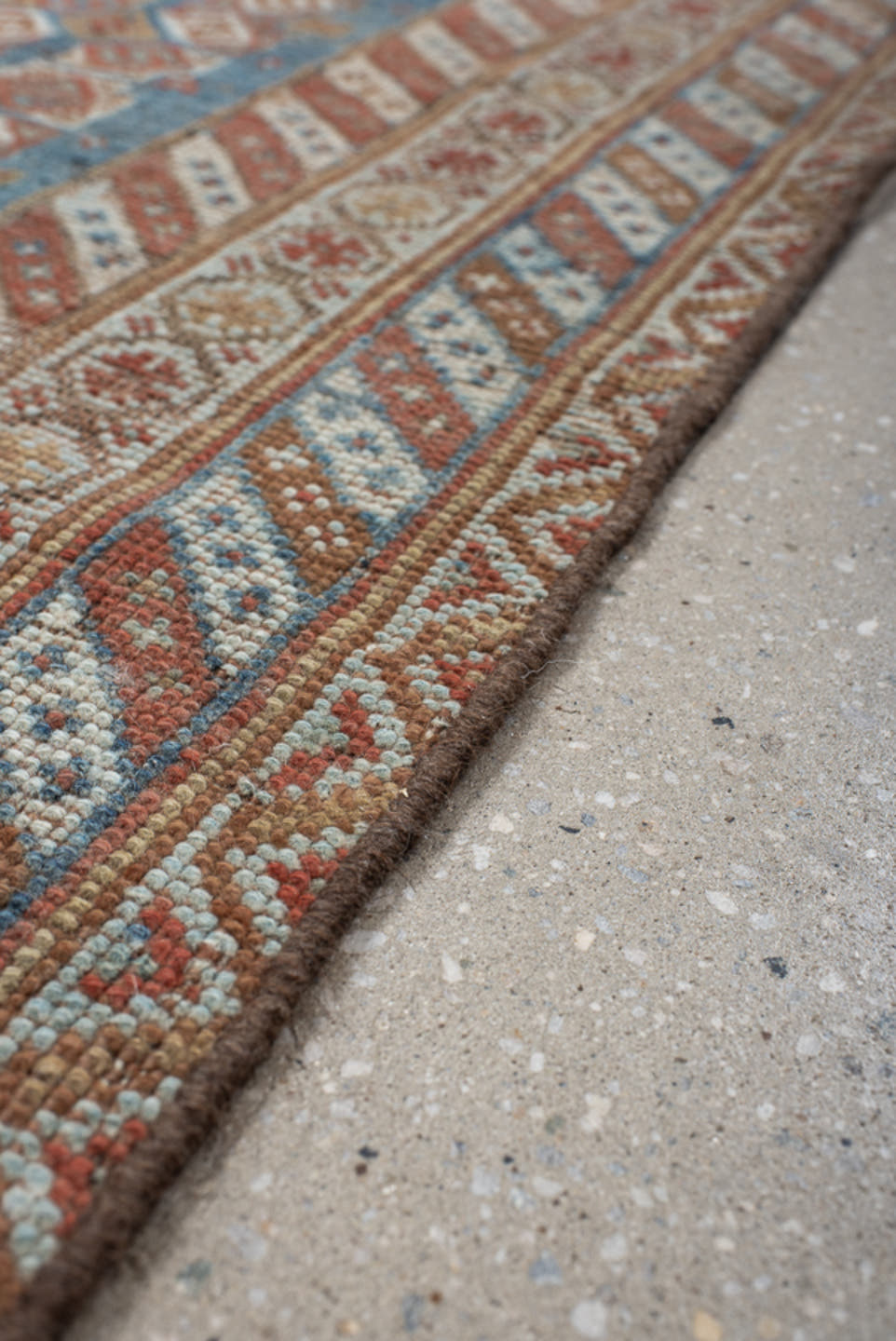 4' x 7' one-of-a-kind handmade vintage Shiraz rug. Color palette: terra cotta, camel, blue, ivory, rust, taupe, terracotta