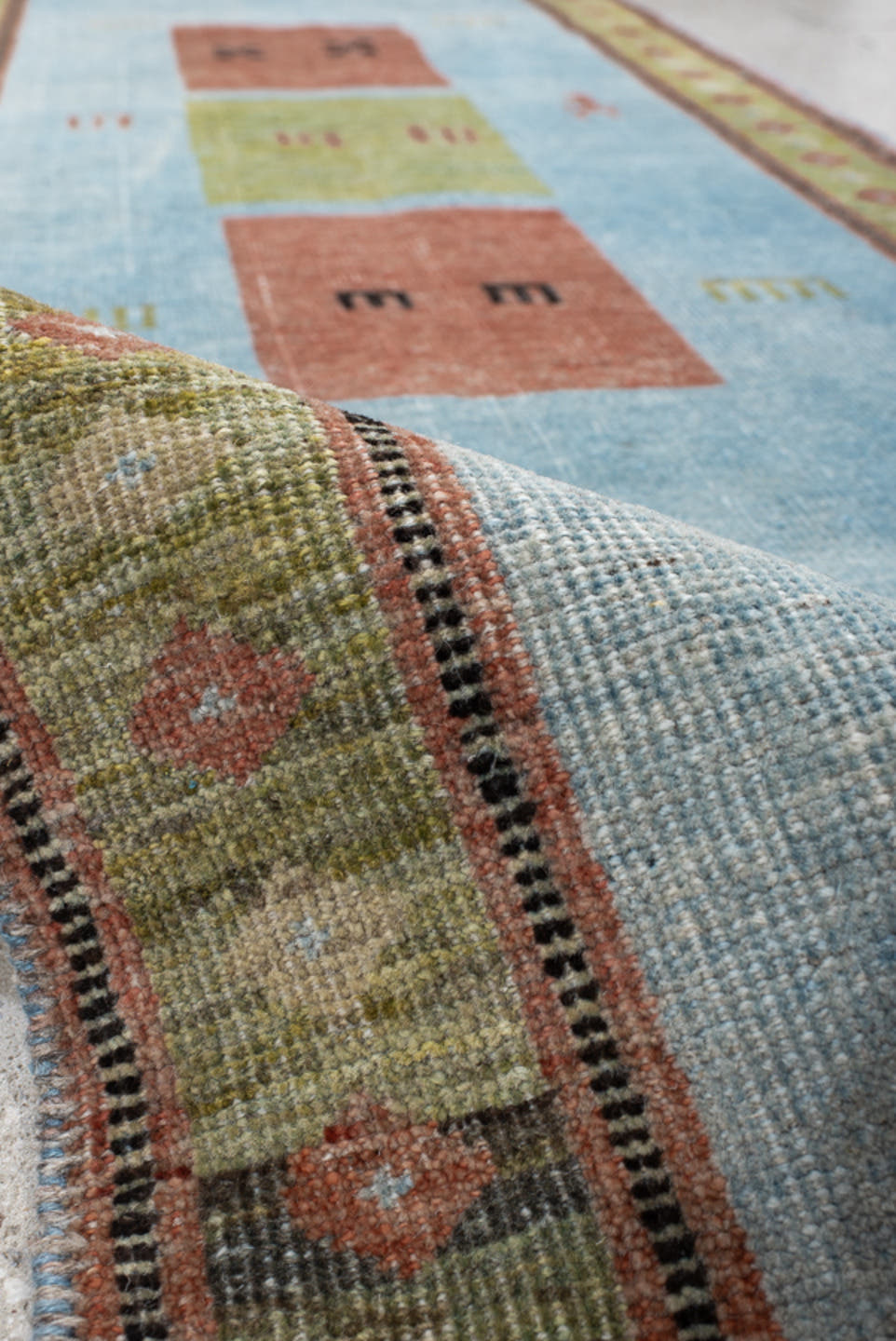 3' x 9' one-of-a-kind handmade vintage Gabbe runner rug. Color palette: sky blue, sage, rust, olive, ivory, charcoal, rose