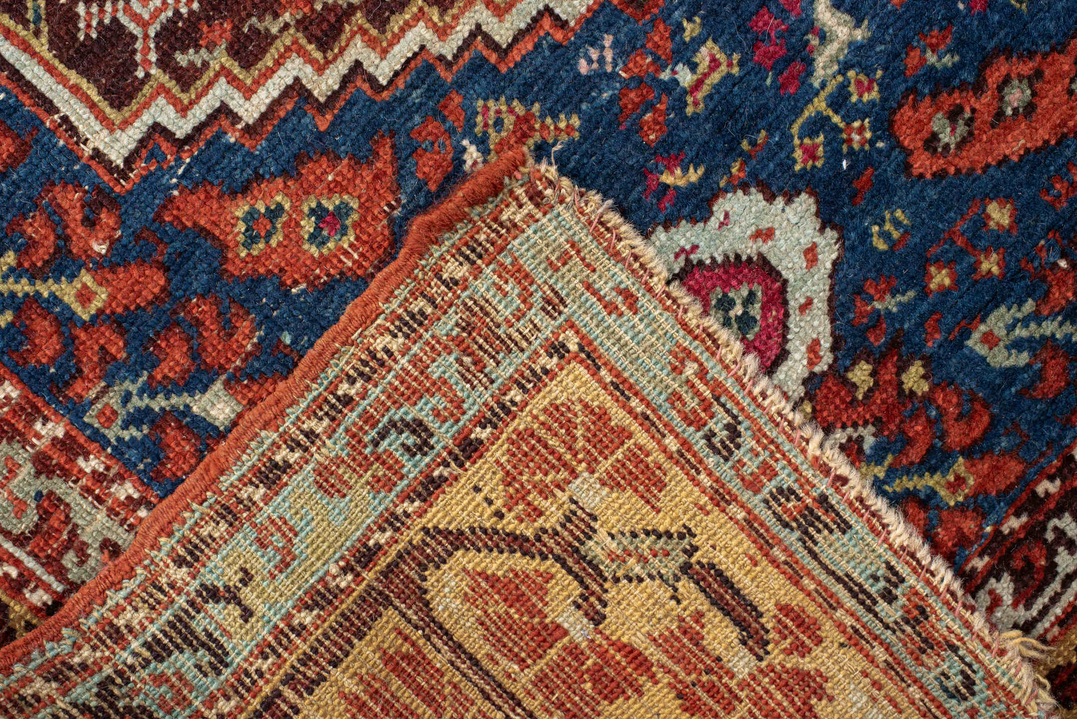 4' x 5' one-of-a-kind handmade vintage Anatolian small size rug. Color palette: rust, indigo, ivory, burgundy, sky blue