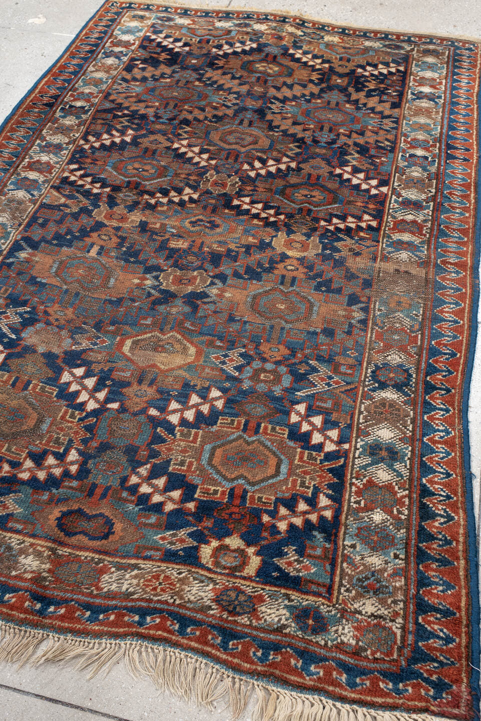 4' x 7' one-of-a-kind handmade vintage Kurd rug. Color palette: navy, rust, ivory, camel, sky blue, taupe, terracotta, blue