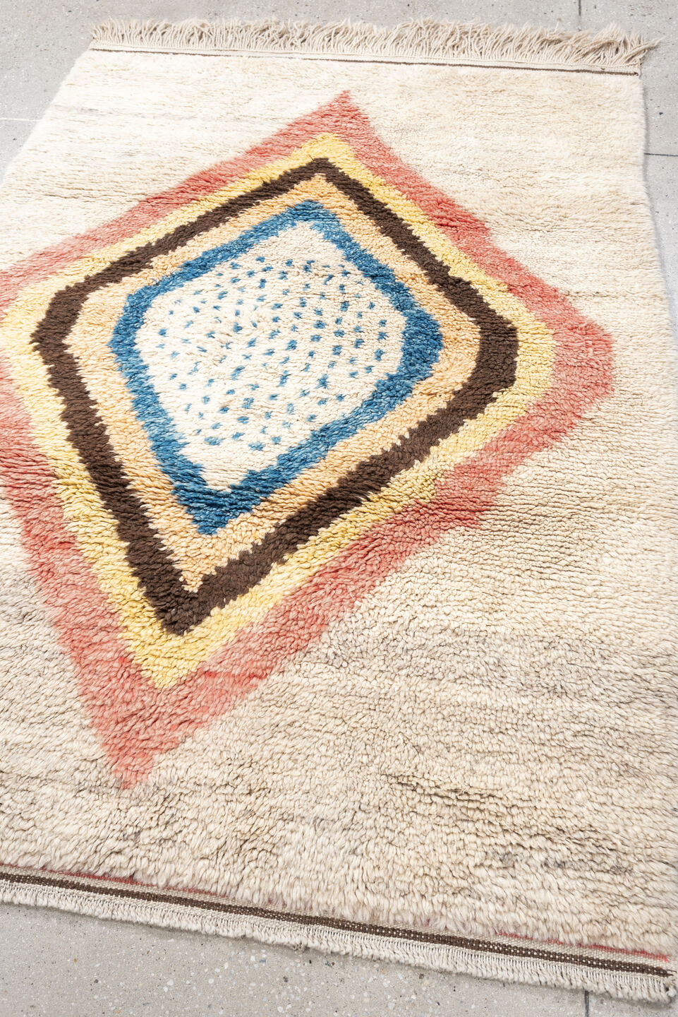 4' x 6' one-of-a-kind handmade vintage Moroccan small size rug. Color palette: ivory, rose, brown, blue, gold, peach, taupe