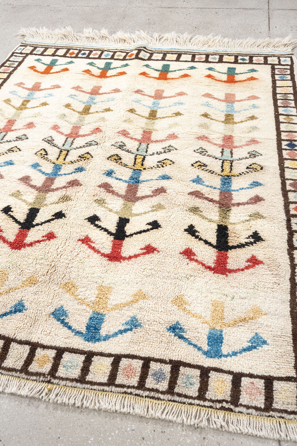 5' x 7' one-of-a-kind handmade vintage Tulu rug. Color palette: ivory, brown, sky blue, coral, blush, mustard, black, sage