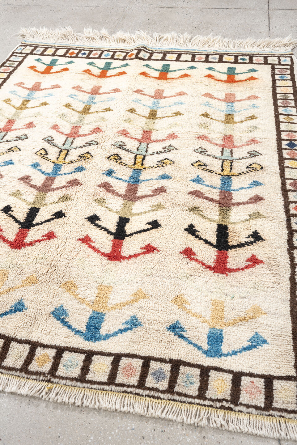 5' x 7' one-of-a-kind handmade vintage Tulu rug. Color palette: ivory, brown, sky blue, coral, blush, mustard, black, sage