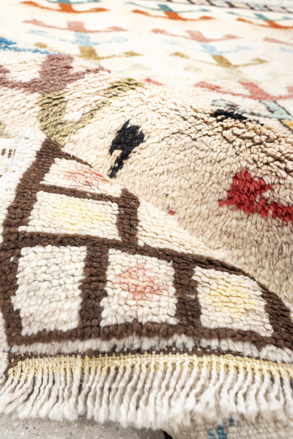 5' x 7' one-of-a-kind handmade vintage Tulu rug. Color palette: ivory, brown, sky blue, coral, blush, mustard, black, sage