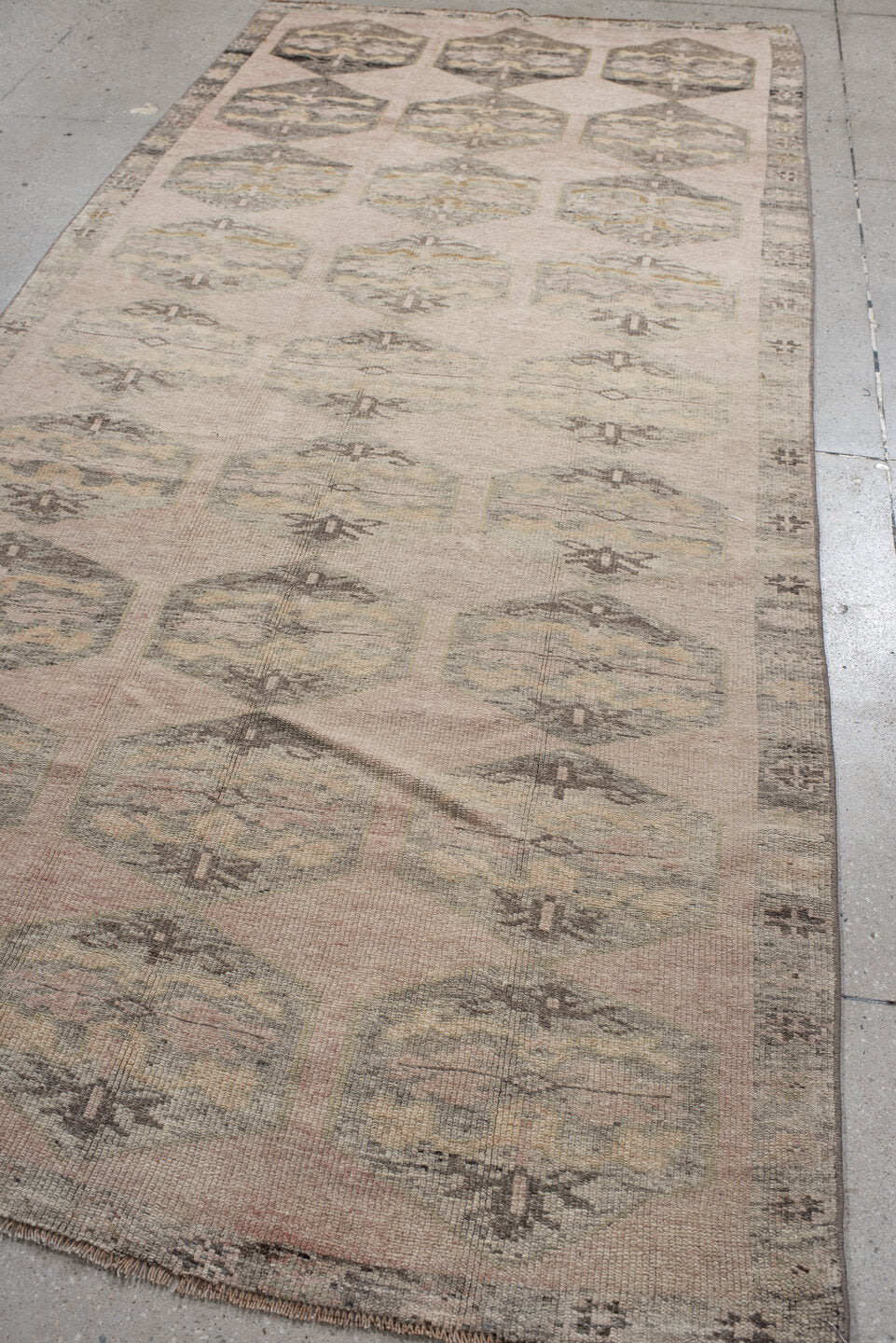 4' x 9' one-of-a-kind handmade vintage Kars runner rug. Color palette: brown, gray, light gray, off-white, orange, pink