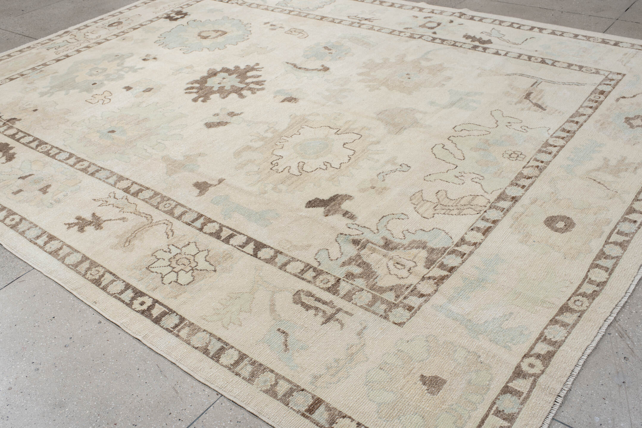 9' x 12' one-of-a-kind handmade vintage Oushak large size rug. Color palette: ivory, cream, taupe, sky_blue, brown, beige