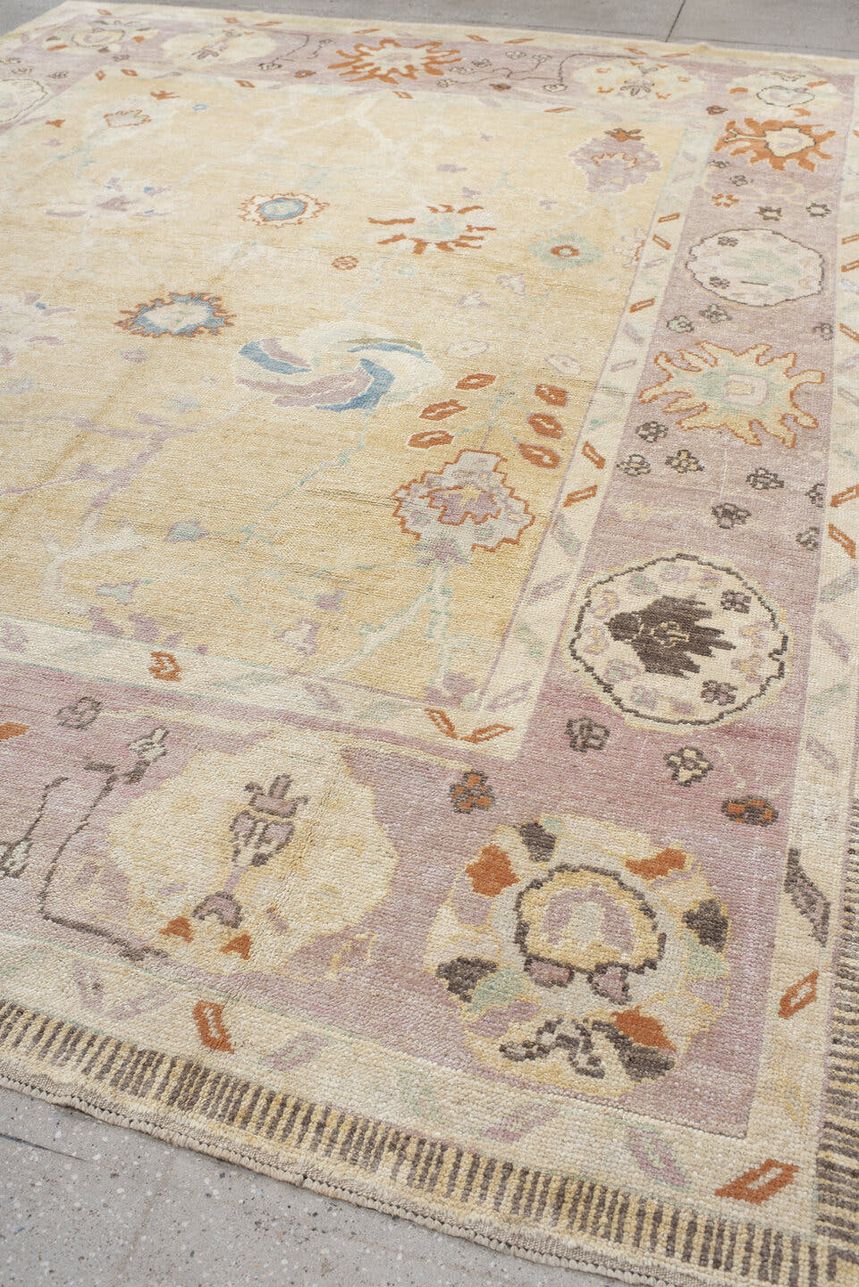 9' x 11' one-of-a-kind handmade vintage Oushak large size rug. Color palette: ivory, lavender, peach, pale gold, sky blue
