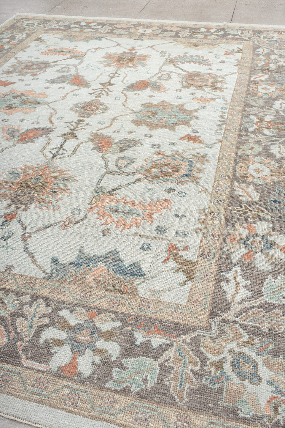 9' x 12' one-of-a-kind handmade vintage Oushak large size rug. Color palette: ivory, taupe, sage, muted blue, coral, brown