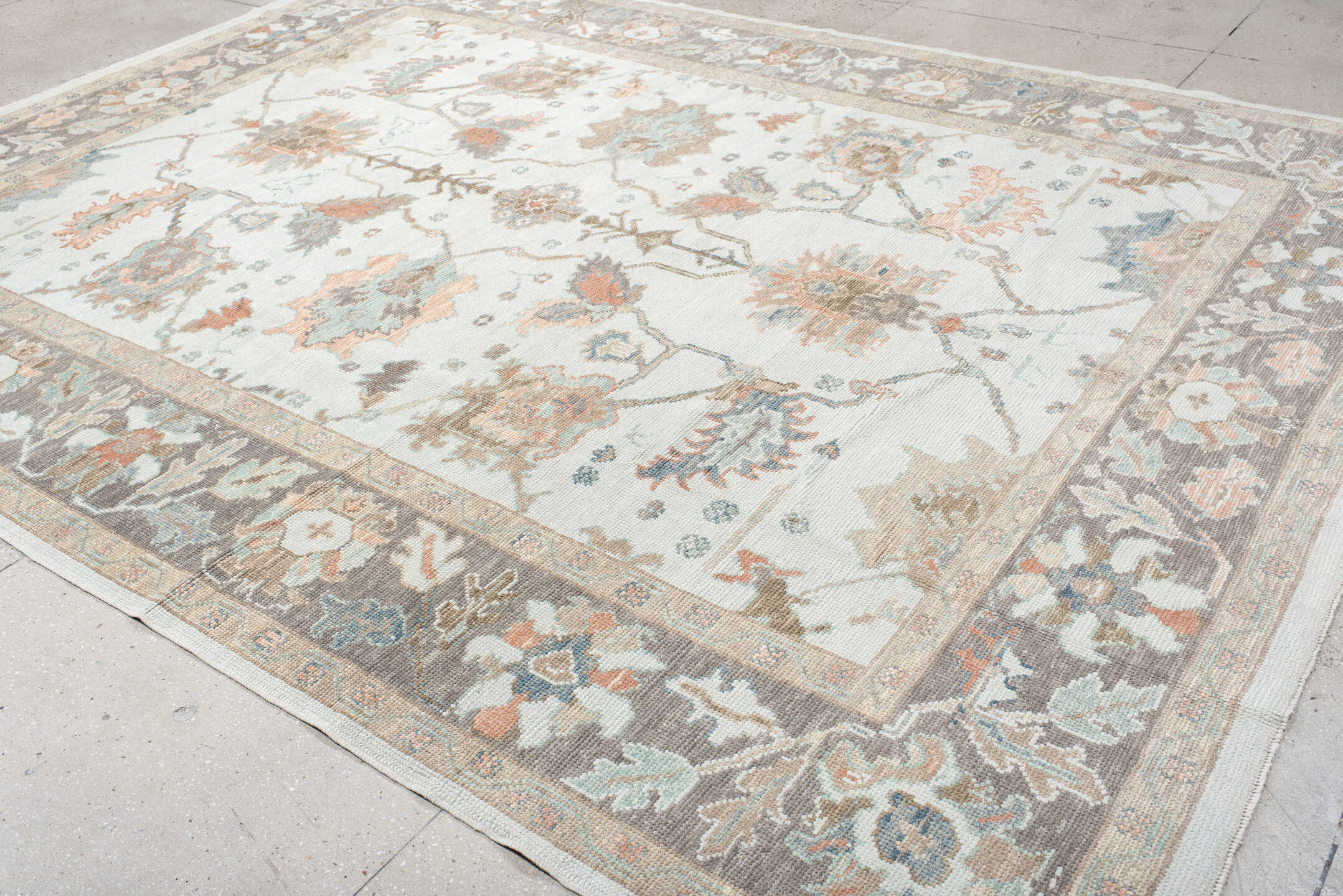 9' x 12' one-of-a-kind handmade vintage Oushak large size rug. Color palette: ivory, taupe, sage, muted blue, coral, brown