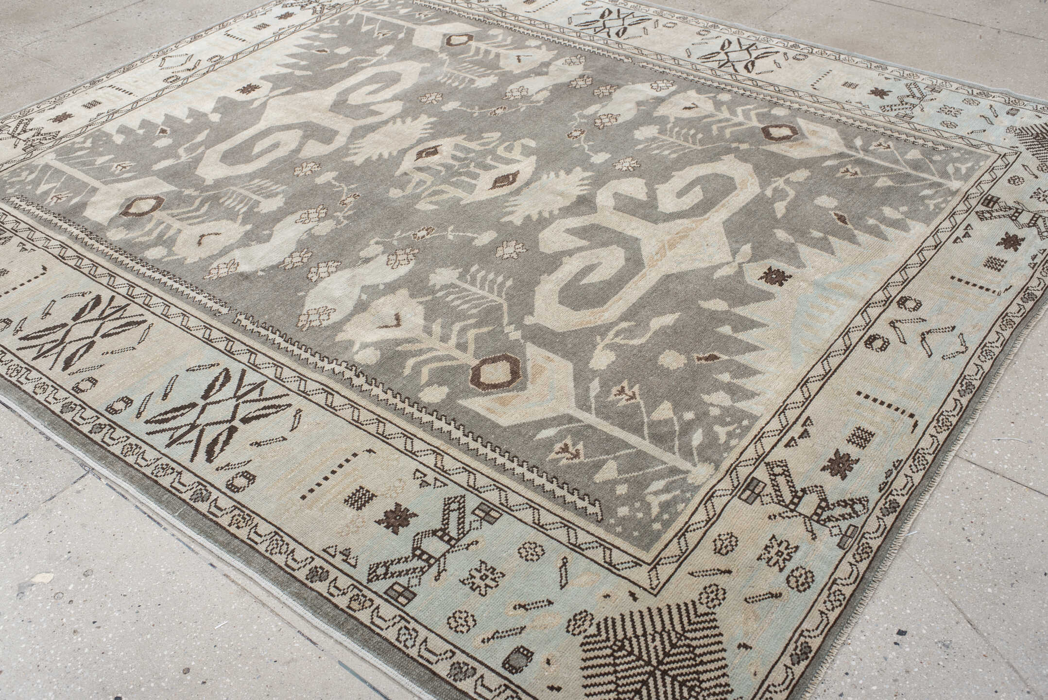7' x 9' one-of-a-kind handmade vintage Anatolian rug. Color palette: charcoal, ivory, pale blue, taupe, brown, black, gray