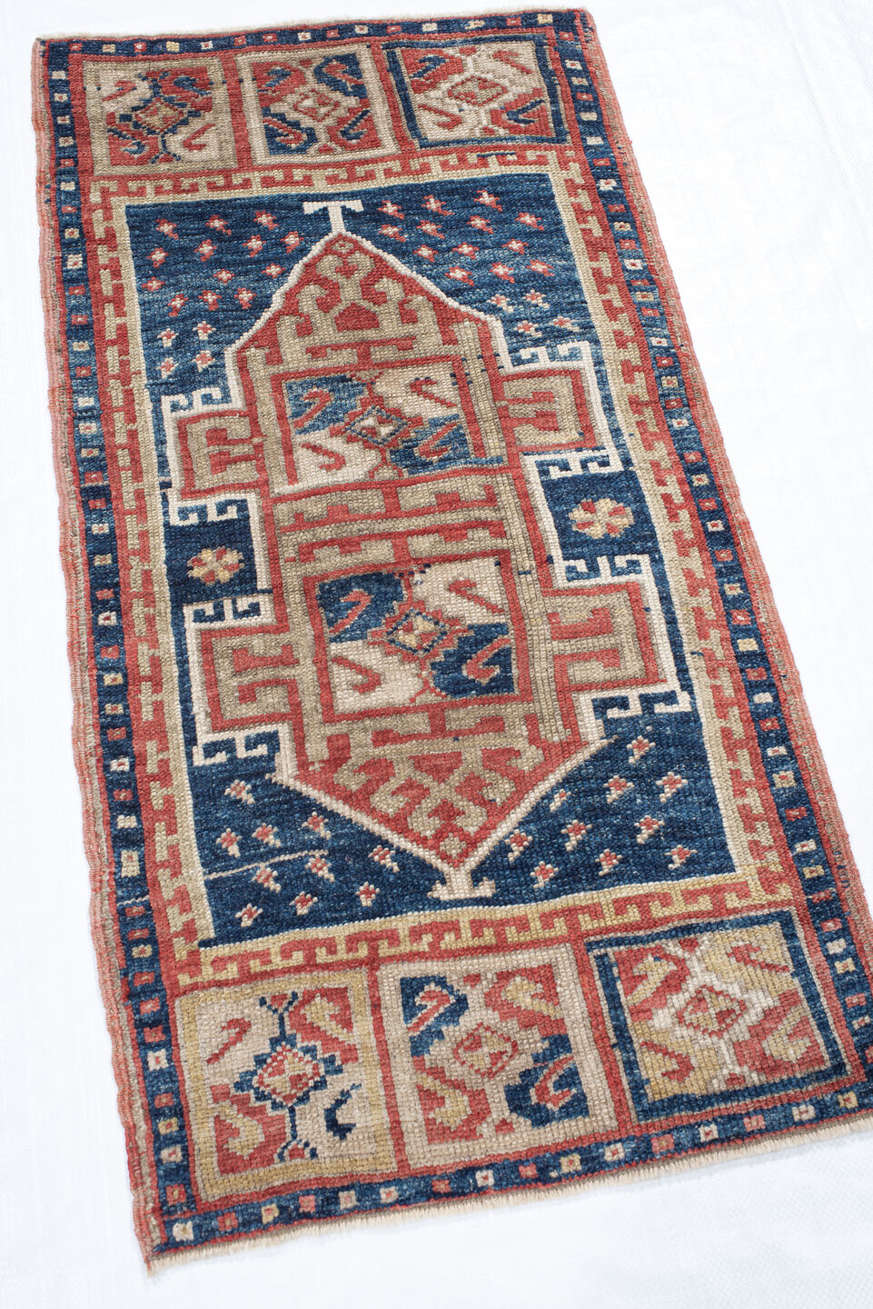 1' x 3' one-of-a-kind handmade vintage Anatolian small size rug. Color palette: navy, ivory, rust, brick, cream, blue