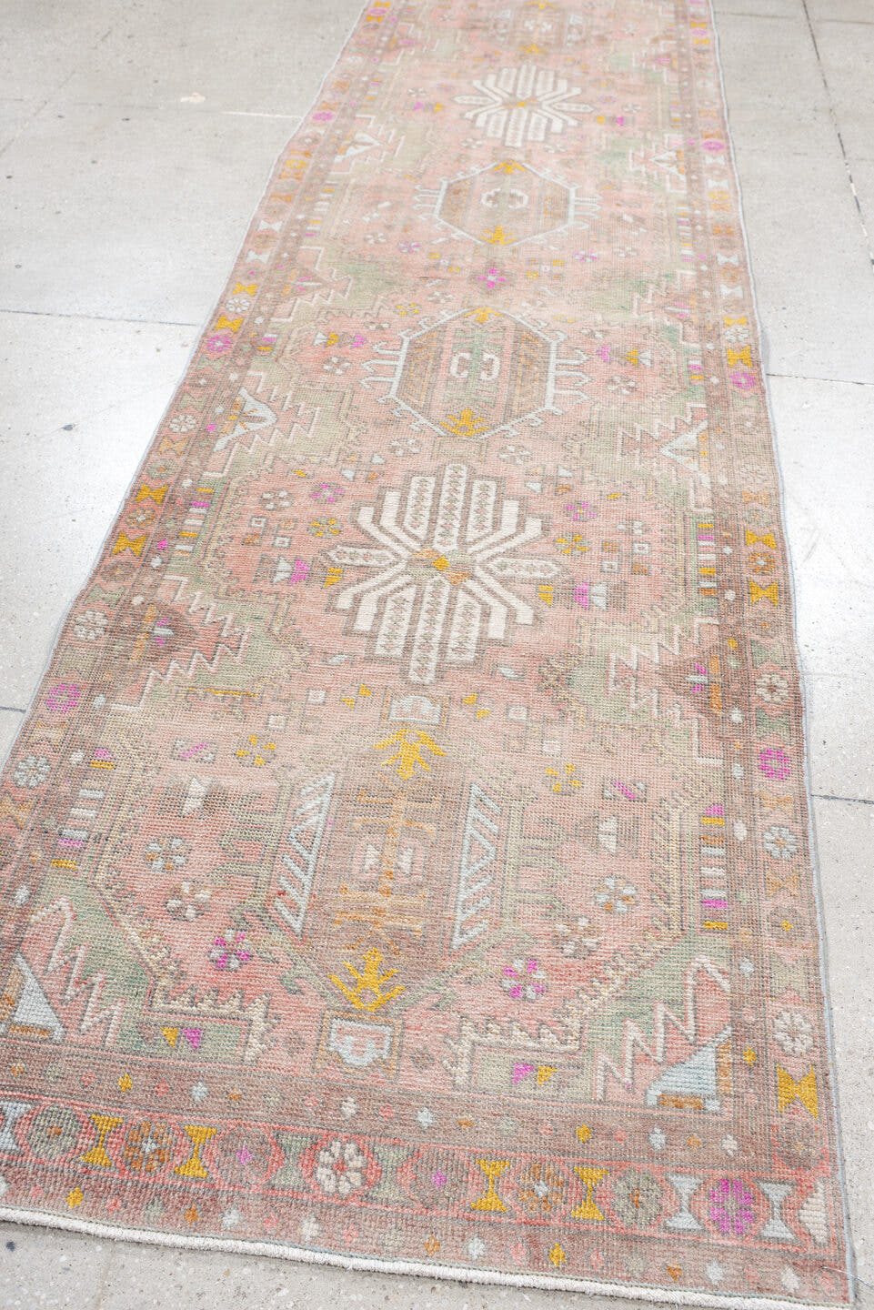 3' x 12' one-of-a-kind handmade vintage Anatolian runner rug. Color palette: blush, taupe, ivory, sage, gold, rose, peach