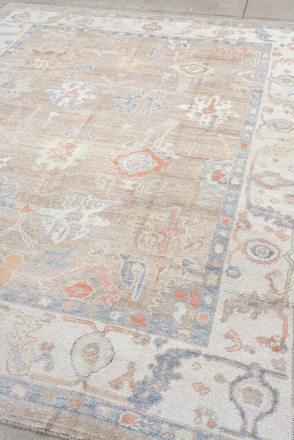 8' x 9' one-of-a-kind handmade vintage Oushak rug. Color palette: taupe, ivory, pale blue, coral, peach, beige, sage, gray
