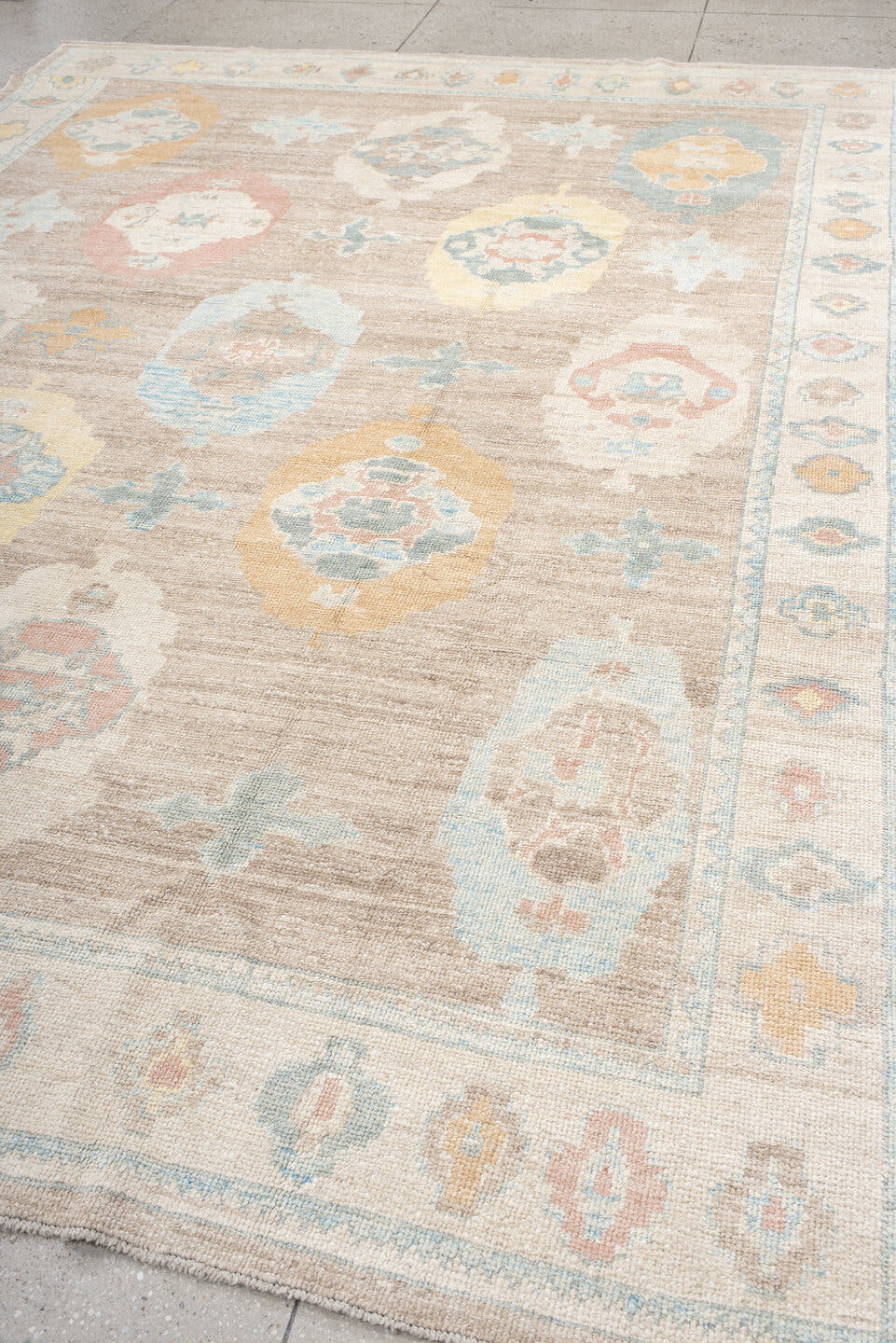 9' x 12' one-of-a-kind handmade vintage Oushak large size rug. Color palette: taupe, ivory, pale blue, peach, soft gold