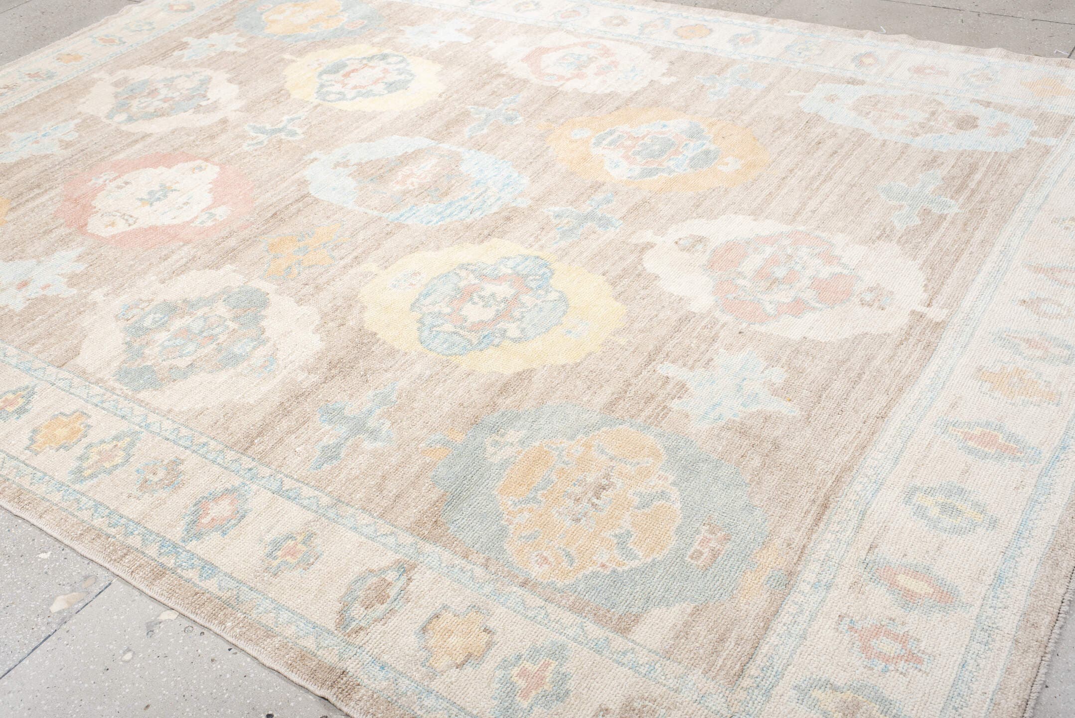 9' x 12' one-of-a-kind handmade vintage Oushak large size rug. Color palette: taupe, ivory, pale blue, peach, soft gold
