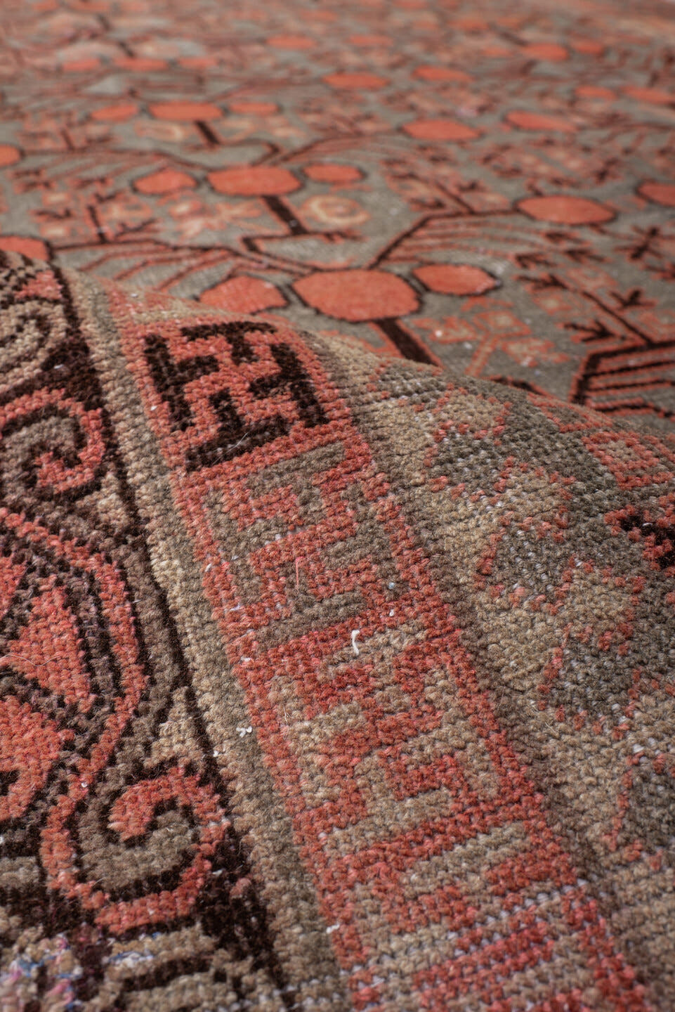 5' x 9' one-of-a-kind handmade antique Khotan medium size rug. Color palette: terra cotta, taupe, charcoal, ivory, rust