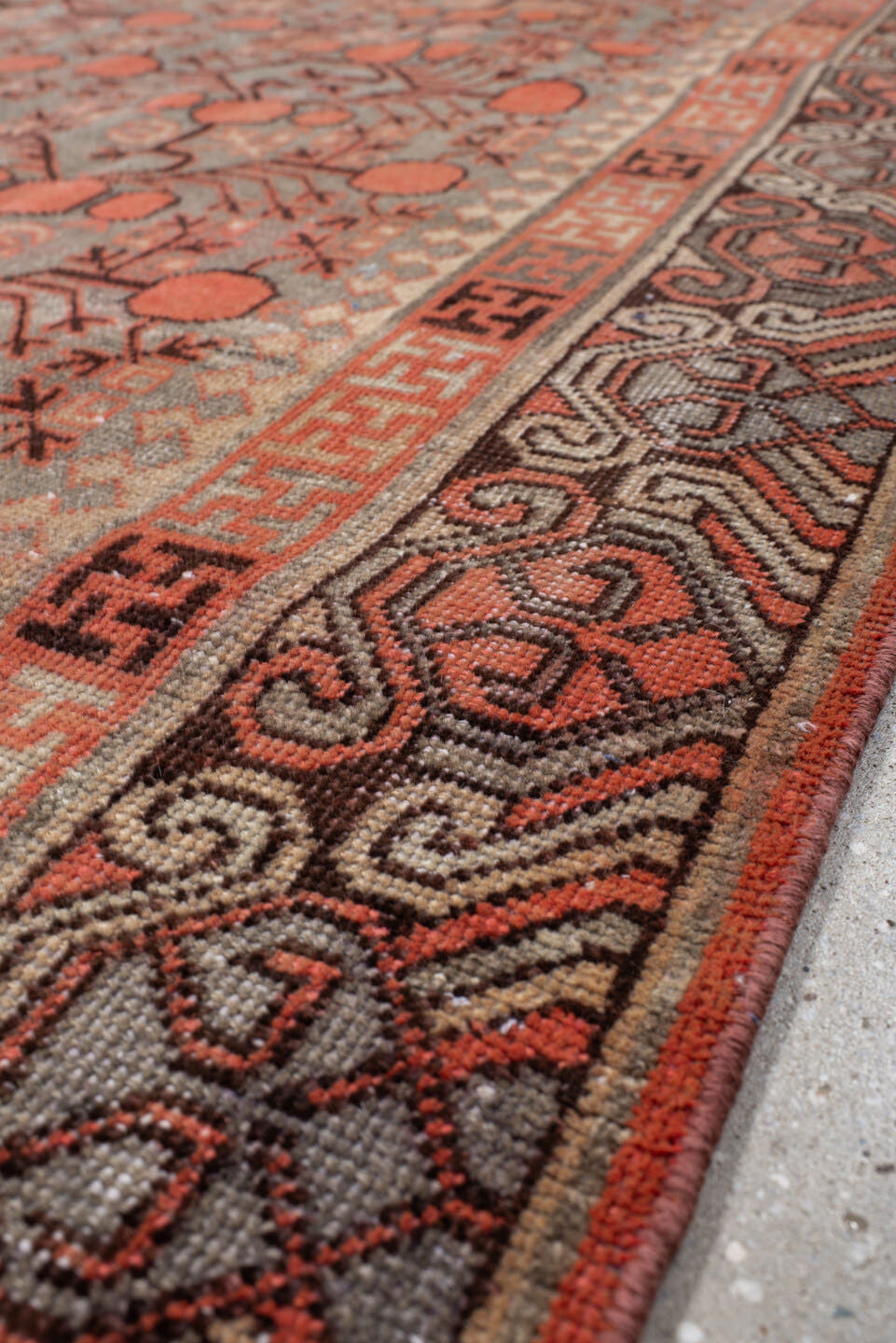 5' x 9' one-of-a-kind handmade antique Khotan medium size rug. Color palette: terra cotta, taupe, charcoal, ivory, rust