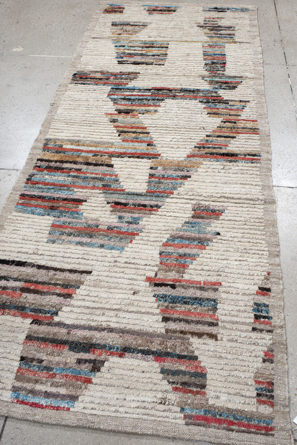 3' x 8' one-of-a-kind handmade vintage Tulu runner rug. Color palette: ivory, taupe, sky blue, rust, charcoal, camel, gray