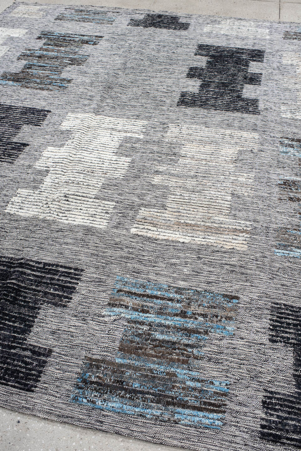 7' x 9' one-of-a-kind handmade vintage Tulu rug. Color palette: gray, charcoal, ivory, turquoise, taupe, black, teal, beige