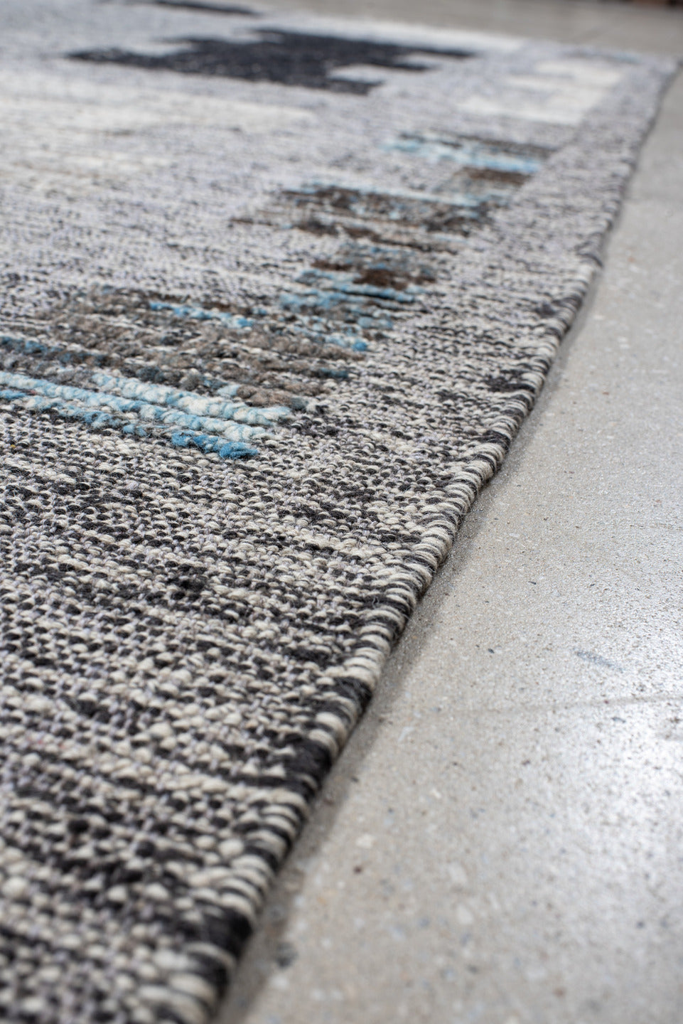 7' x 9' one-of-a-kind handmade vintage Tulu rug. Color palette: gray, charcoal, ivory, turquoise, taupe, black, teal, beige