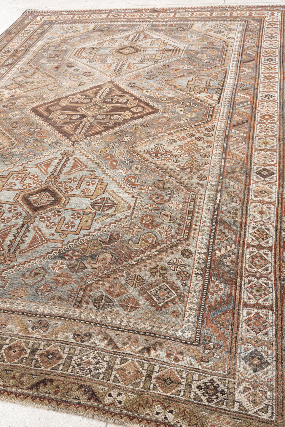 6' x 9' one-of-a-kind handmade antique Qashqai rug. Color palette: taupe, ivory, rust, slate, brown, camel, charcoal, beige