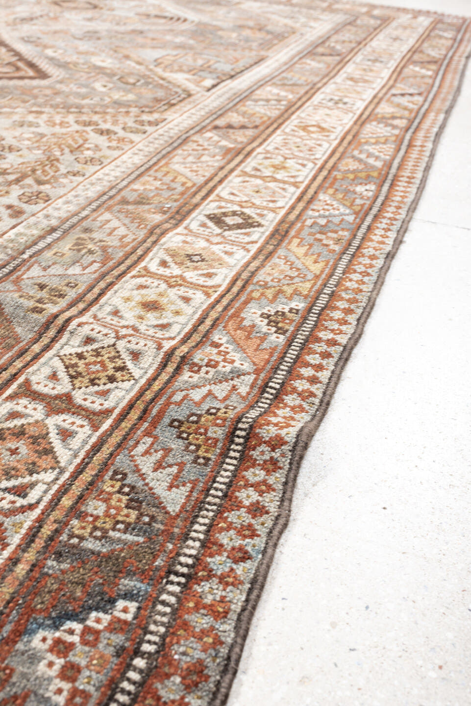 6' x 9' one-of-a-kind handmade antique Qashqai rug. Color palette: taupe, ivory, rust, slate, brown, camel, charcoal, beige