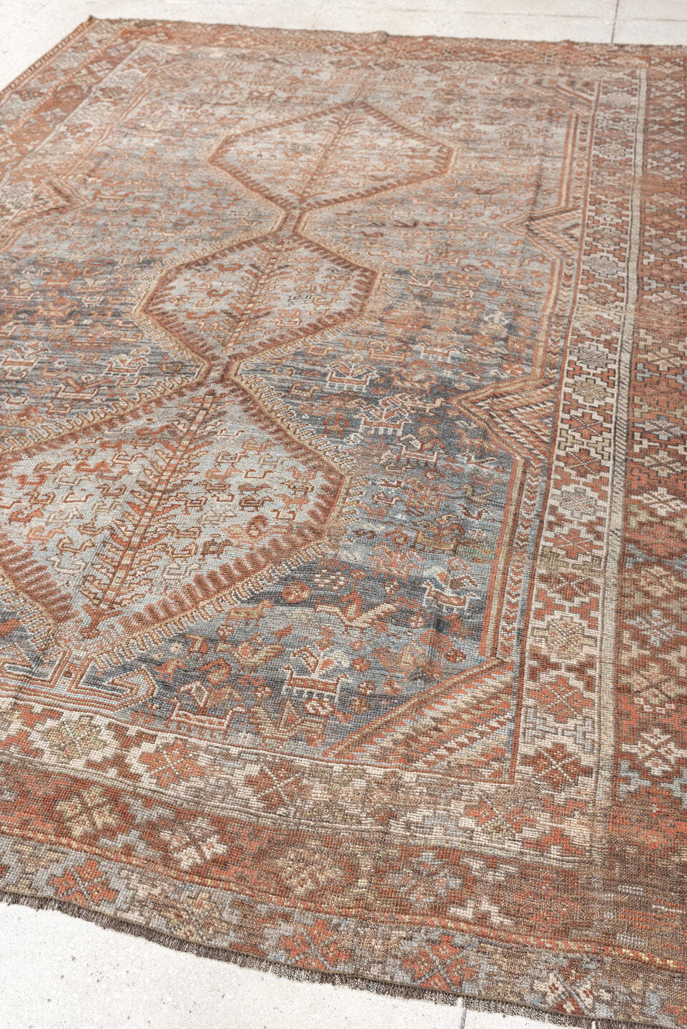 6' x 8' one-of-a-kind handmade antique Shiraz medium size rug. Color palette: blue, rust, ivory, taupe, slate, camel