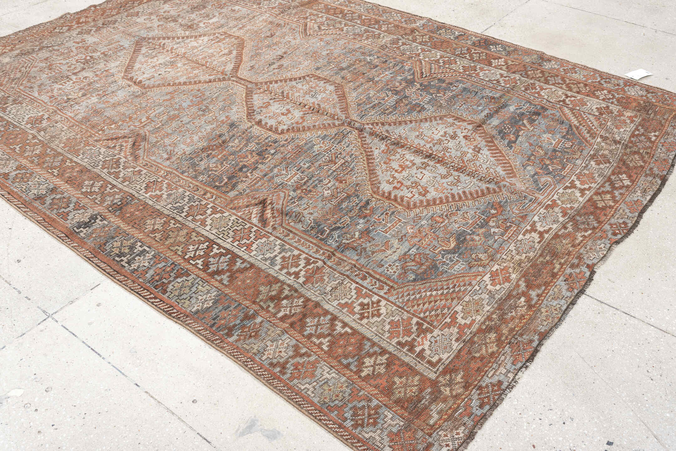 6' x 8' one-of-a-kind handmade antique Shiraz medium size rug. Color palette: blue, rust, ivory, taupe, slate, camel