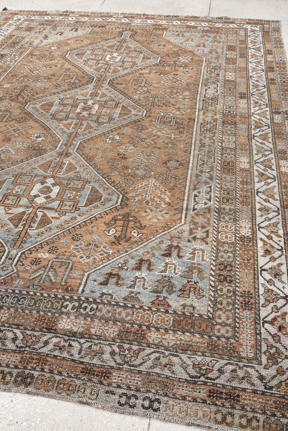 7' x 10' one-of-a-kind handmade antique Shiraz large size rug. Color palette: terra cotta, sky blue, ivory, taupe, brown
