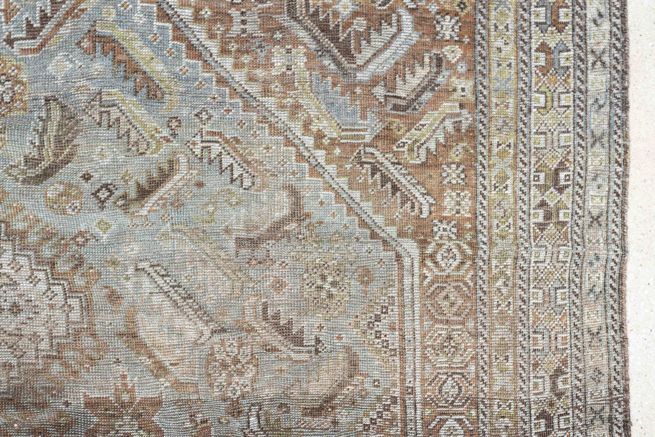 6' x 9' one-of-a-kind handmade antique Shiraz rug. Color palette: light blue, ivory, taupe, rust, brown, gold, camel
