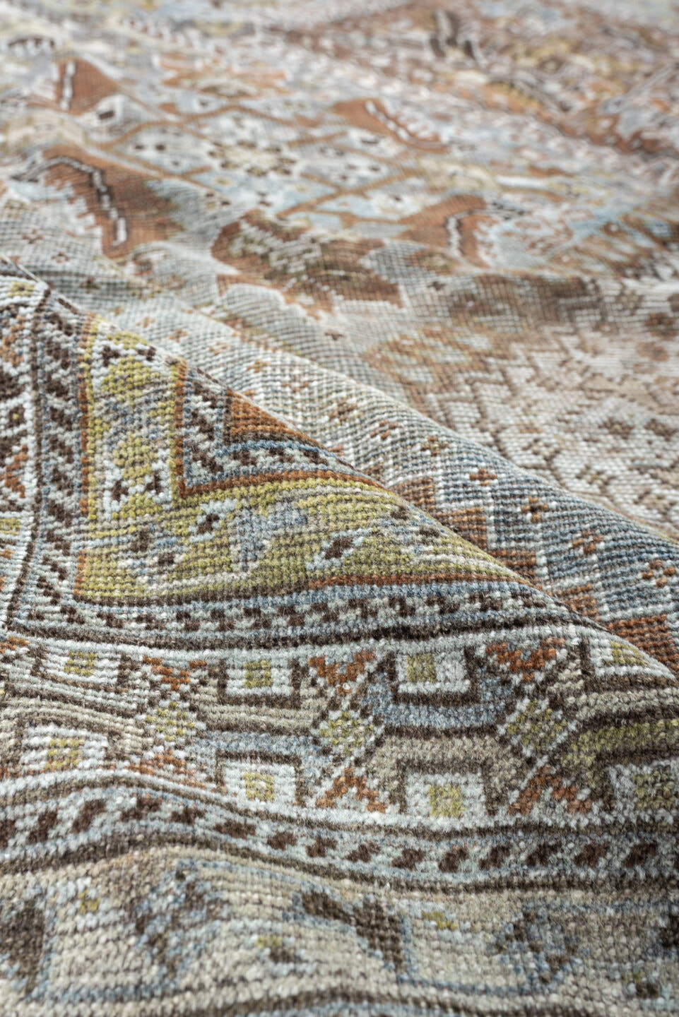 6' x 9' one-of-a-kind handmade antique Shiraz rug. Color palette: light blue, ivory, taupe, rust, brown, gold, camel