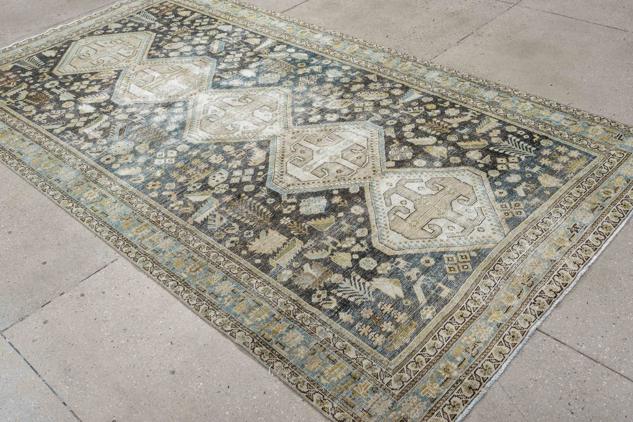 5' x 9' one-of-a-kind handmade antique Qashqai medium size rug. Color palette: charcoal, ivory, sky blue, taupe, beige